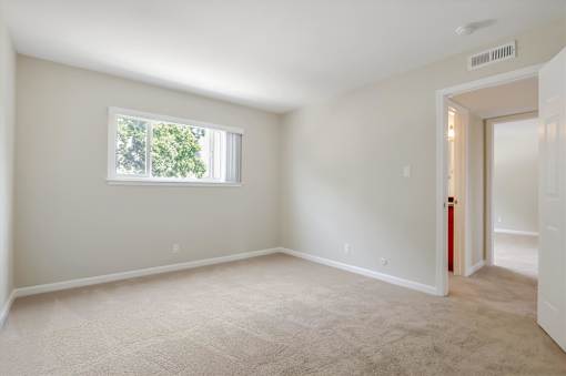 A room with a window and a door.