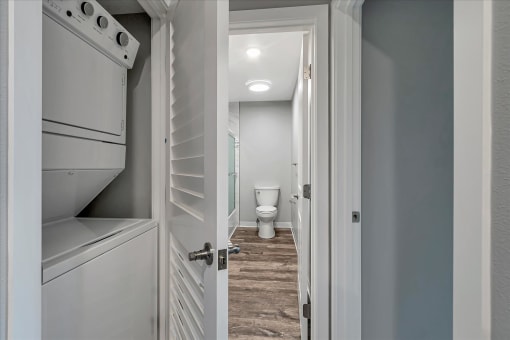 a laundry room with a closet and a toilet