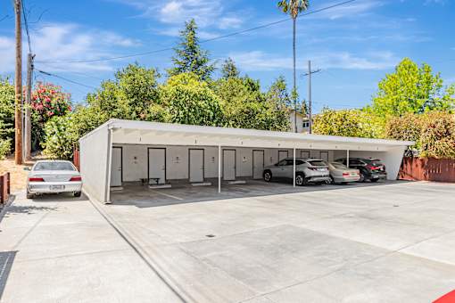 A large garage with a white car parked in front.
