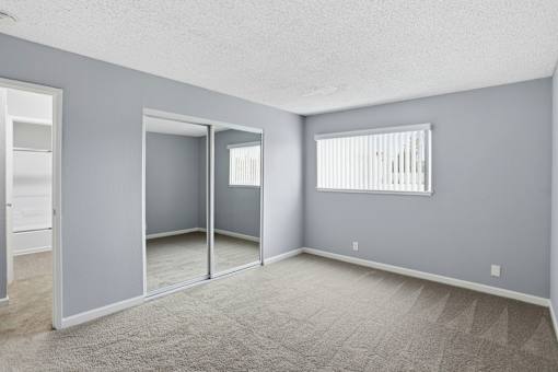 A room with grey walls and a carpeted floor.