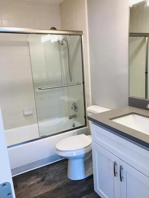 a bathroom with a toilet and a shower