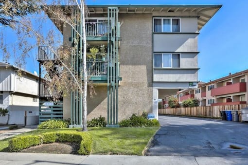a street view of an apartment building with stairs on the side of it