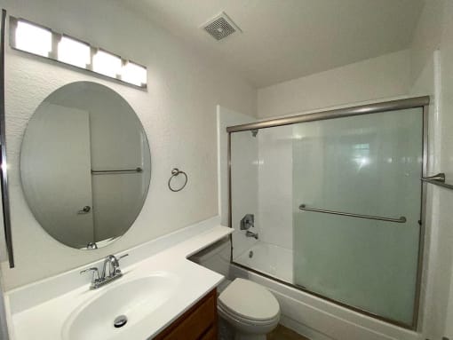 a bathroom with a sink toilet and a shower
