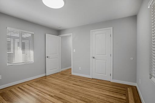 A room with wooden floors and white walls.