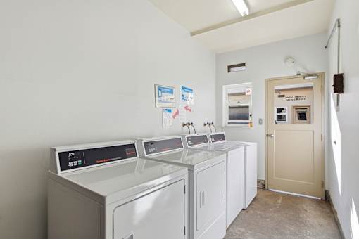 A laundry room with washers and dryers.