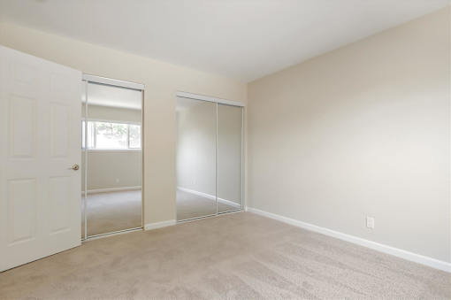 A room with a white door and a sliding glass door.