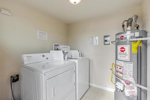 A wall-mounted washing machine with a yellow caution tape around it.