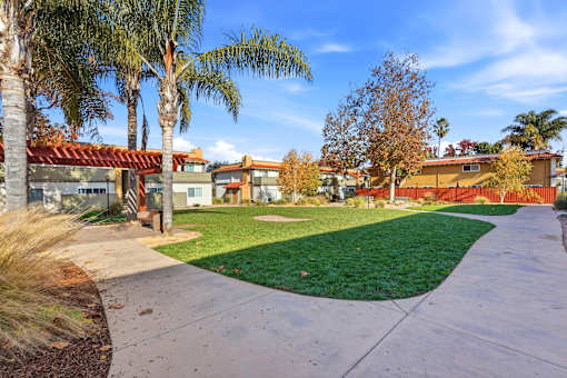 A residential area with houses and palm trees.