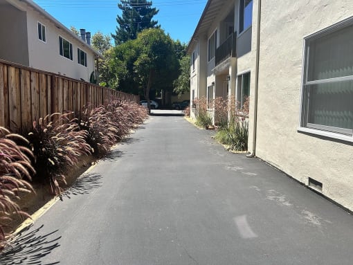 a paved street with a building on both sides of it