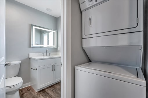 a white bathroom with a refrigerator and a sink