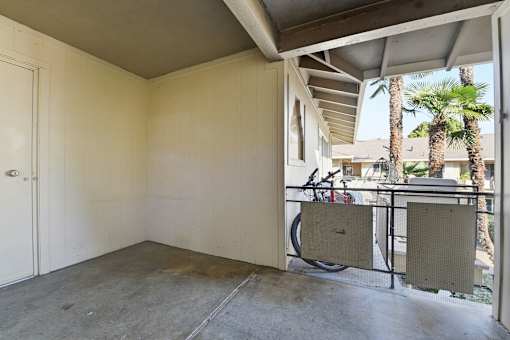 A room with a bicycle leaning against the wall.