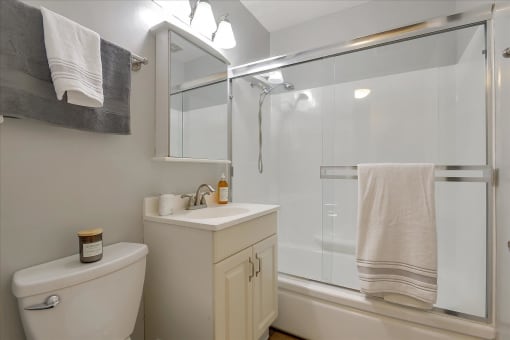 A white toilet sits next to a sink in a bathroom.