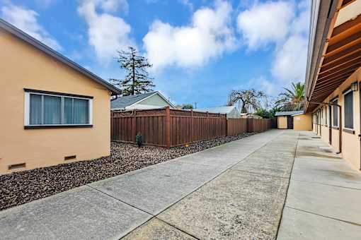 A sunny day in a residential area with a clear blue sky.