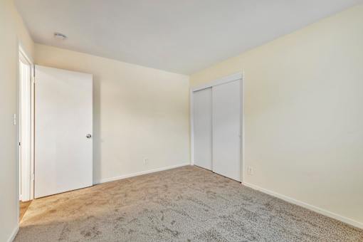 A room with two doors and a carpeted floor.