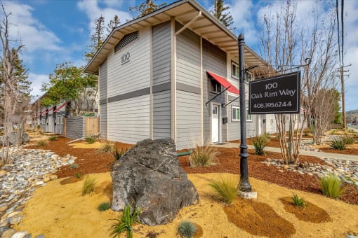 a building with a sign and a rock in front of it