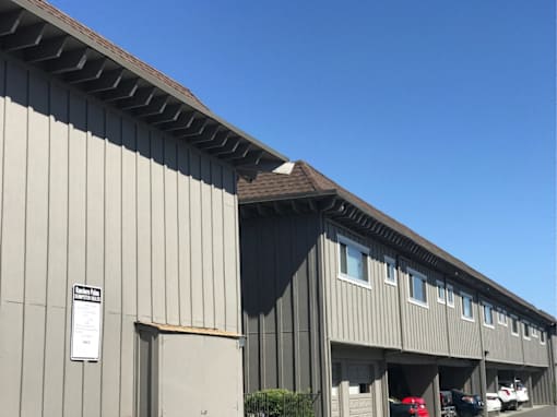 the side of a building with a brown roof
