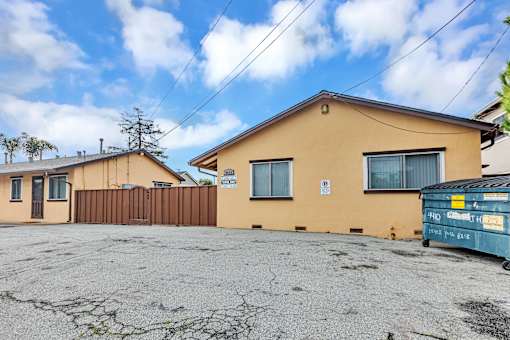 A yellow house with a sign that says "No Parking" on the window.