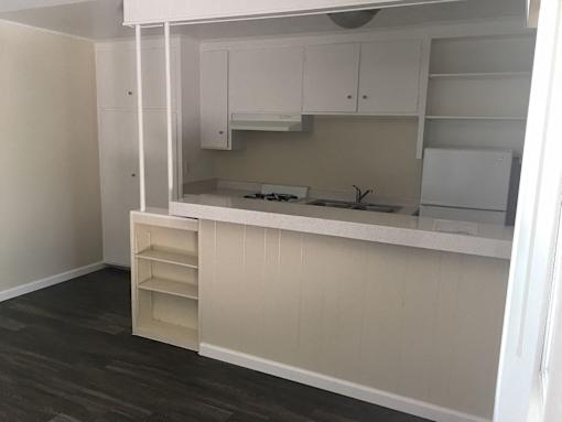 A kitchen with white cabinets and a countertop.