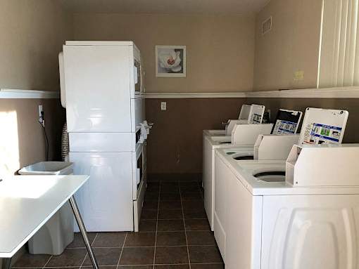 a white kitchen with a counter and a refrigerator