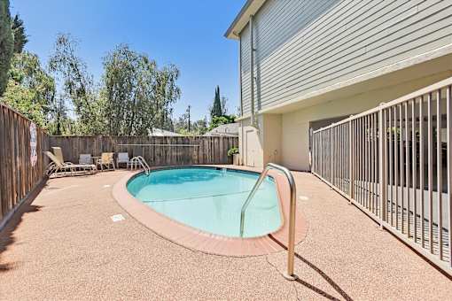 A small pool with a fence around it.