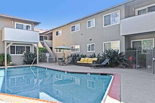 A swimming pool in front of apartment buildings.