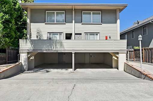 A two-story residential building with a garage.