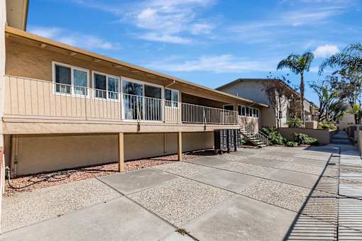 A sunny day at a residential complex with a clear blue sky.