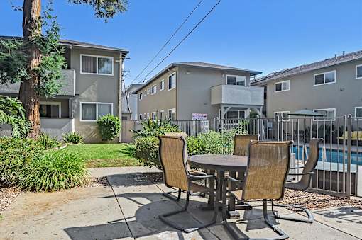 A table and two chairs are set up on a patio.