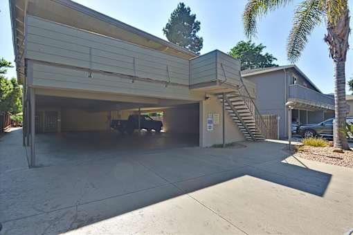 A two-story garage with a car parked inside.