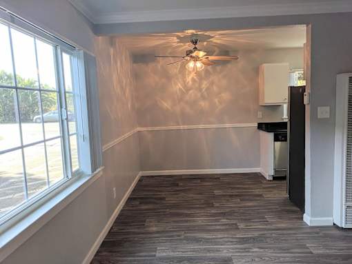 A room with a ceiling fan and a window.