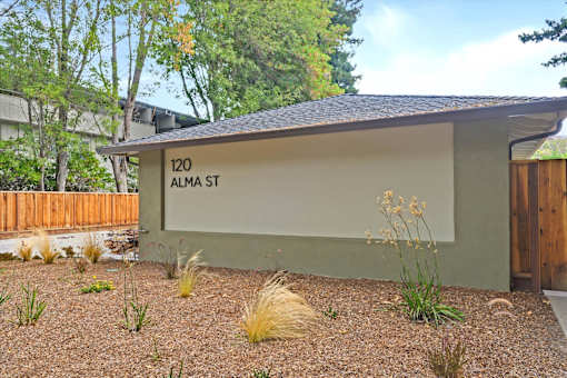 A building with a sign that says 120 Alma St.