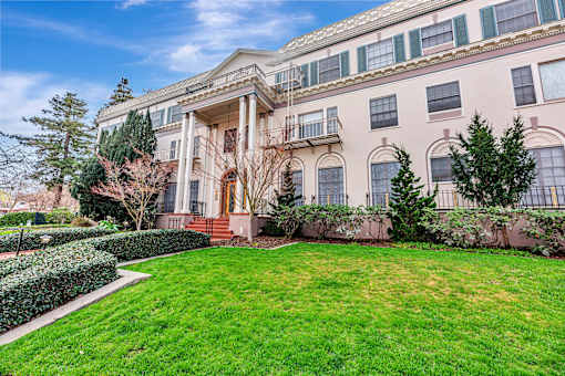 A large, two-story building with a balcony on the second floor.