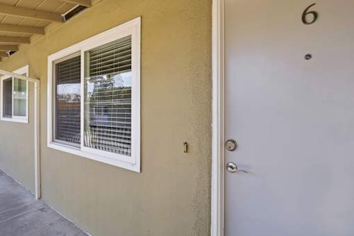 A white door with a number 6 above it.