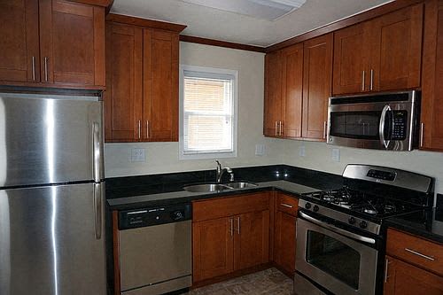 A kitchen with wooden cabinets and stainless steel appliances.
