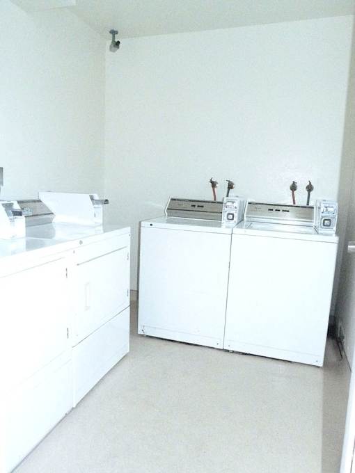 A white cabinet with a microwave on top of it.