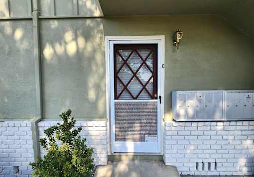 A white door with a diamond pattern in the middle.