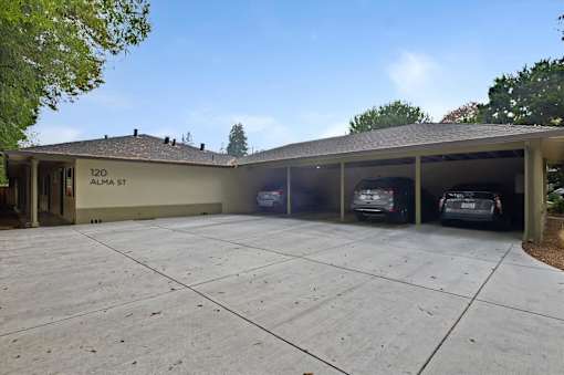 A house with a garage that has two cars parked in it.