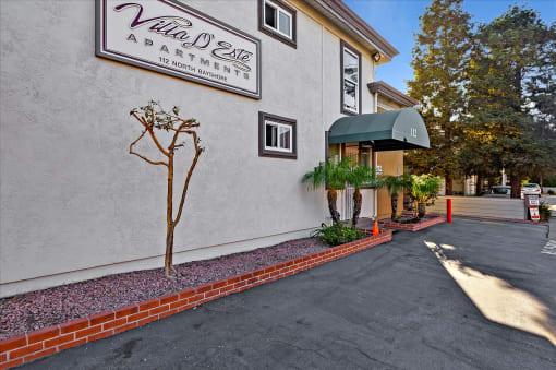 A sign for Villa Mead Apartments is on the side of a building.