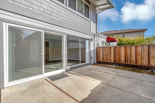 a sliding glass door opens to a patio outside of a house