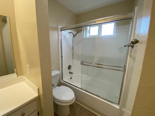a bathroom with a toilet and a rainbow wall