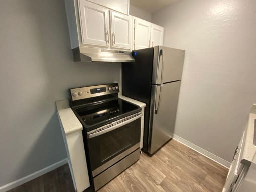 a kitchen with a stove and a refrigerator