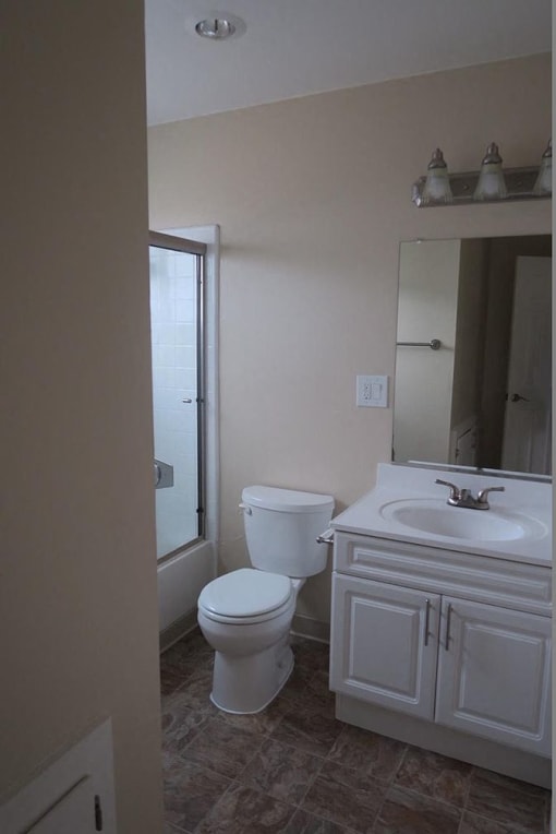 a white bathroom with a toilet and a sink