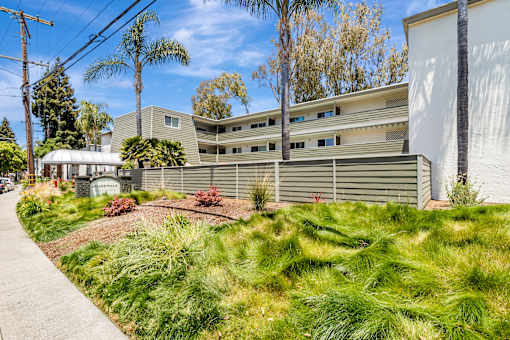 A modern building with a green lawn in front.