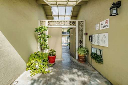 A hallway with a no smoking sign on the wall.