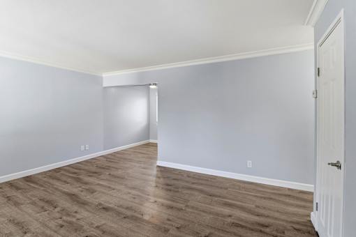A room with a white door and grey walls.