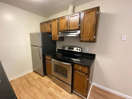 a kitchen with stainless steel appliances and wooden cabinets