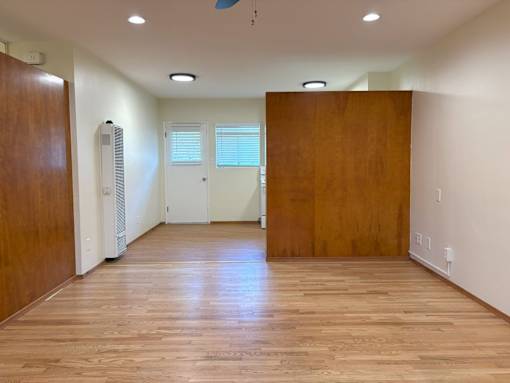 A room with wooden floors and white walls.