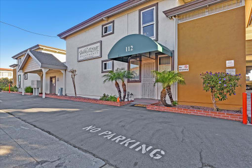 A building with a green awning and the number 112 on it.