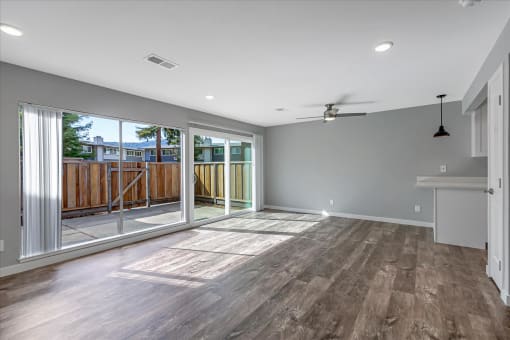a living room with a sliding glass door to a deck