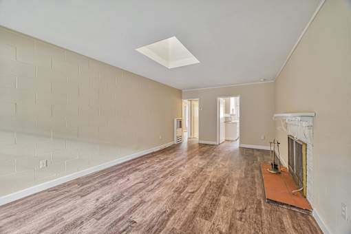 A room with wooden floors and a fireplace.